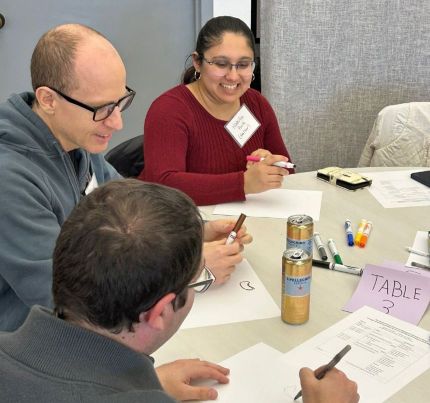 Photo of trainee drawing on paper at program retreat.