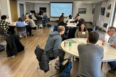 Photo of Attendees at Round Tables at Program Retreat.